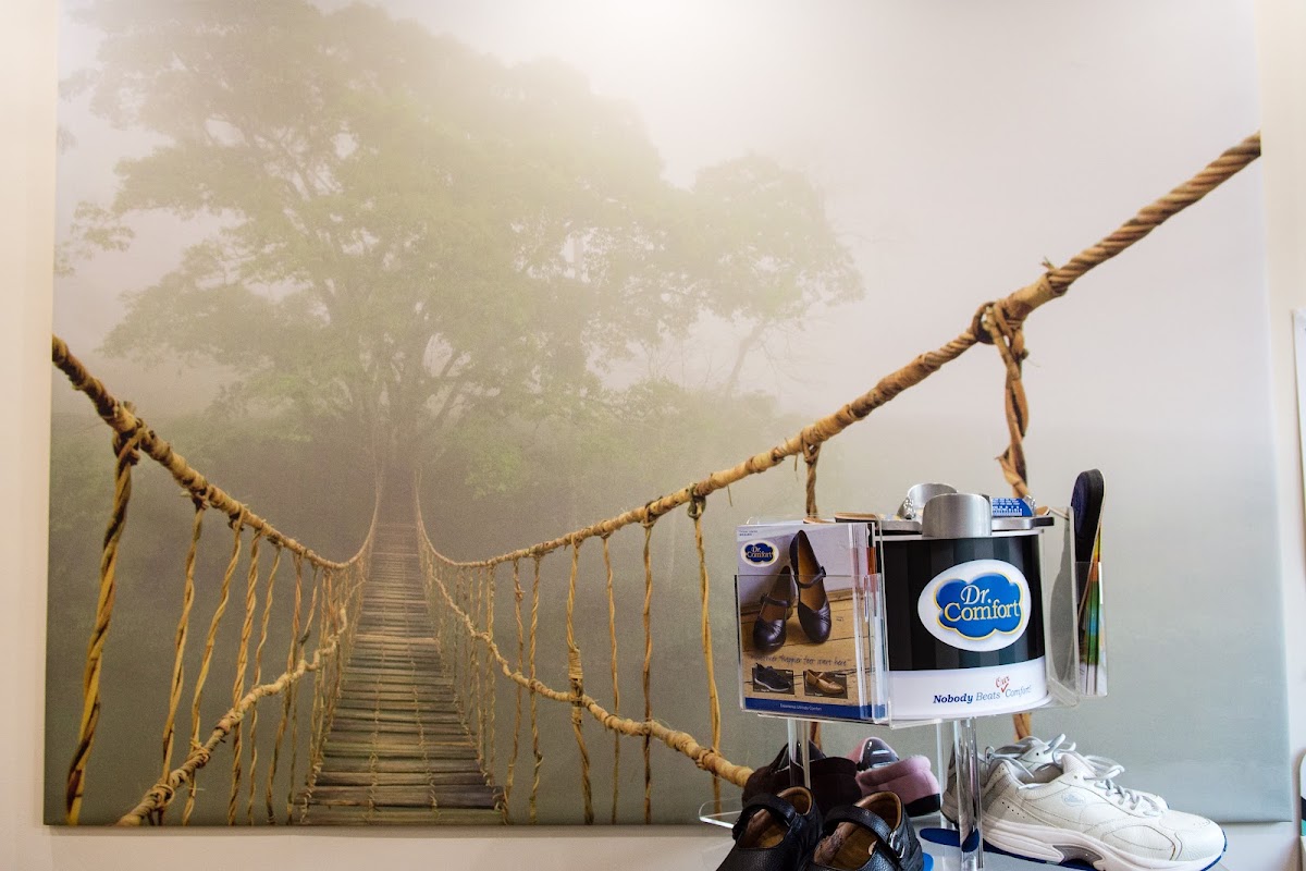 Dr. Comfort footwear display beside a wall canvas